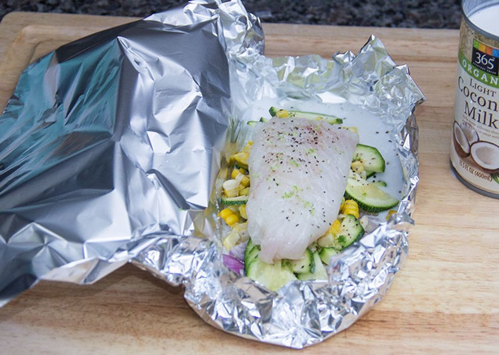 Add some canola oil and coconut milk to the "bowl," along with some lime zest. Place an individual portion of white fish (cod, haddock, or halibut) over the veggies. Season well with salt and pepper.