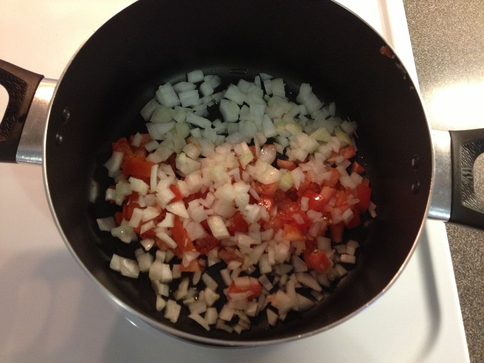 Add some canola oil and fry chopped tomatoes and onions, till onions are clear.