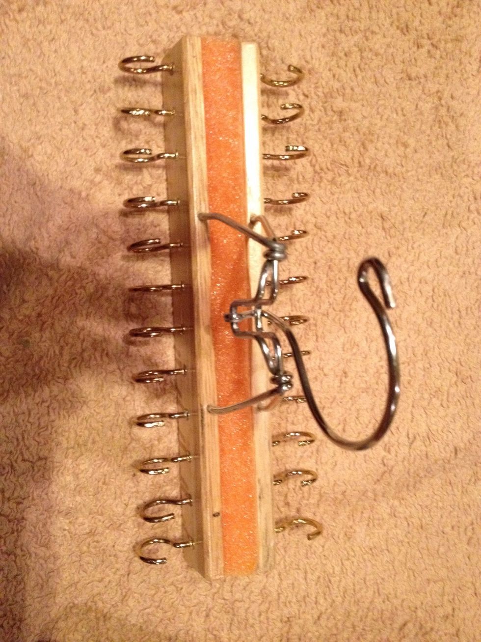 Add some craft glue to both sides of the noodle. Place the foam between the two wooden sections to give the screws something to attach to close by flipping up the hanger. Construction is complete.