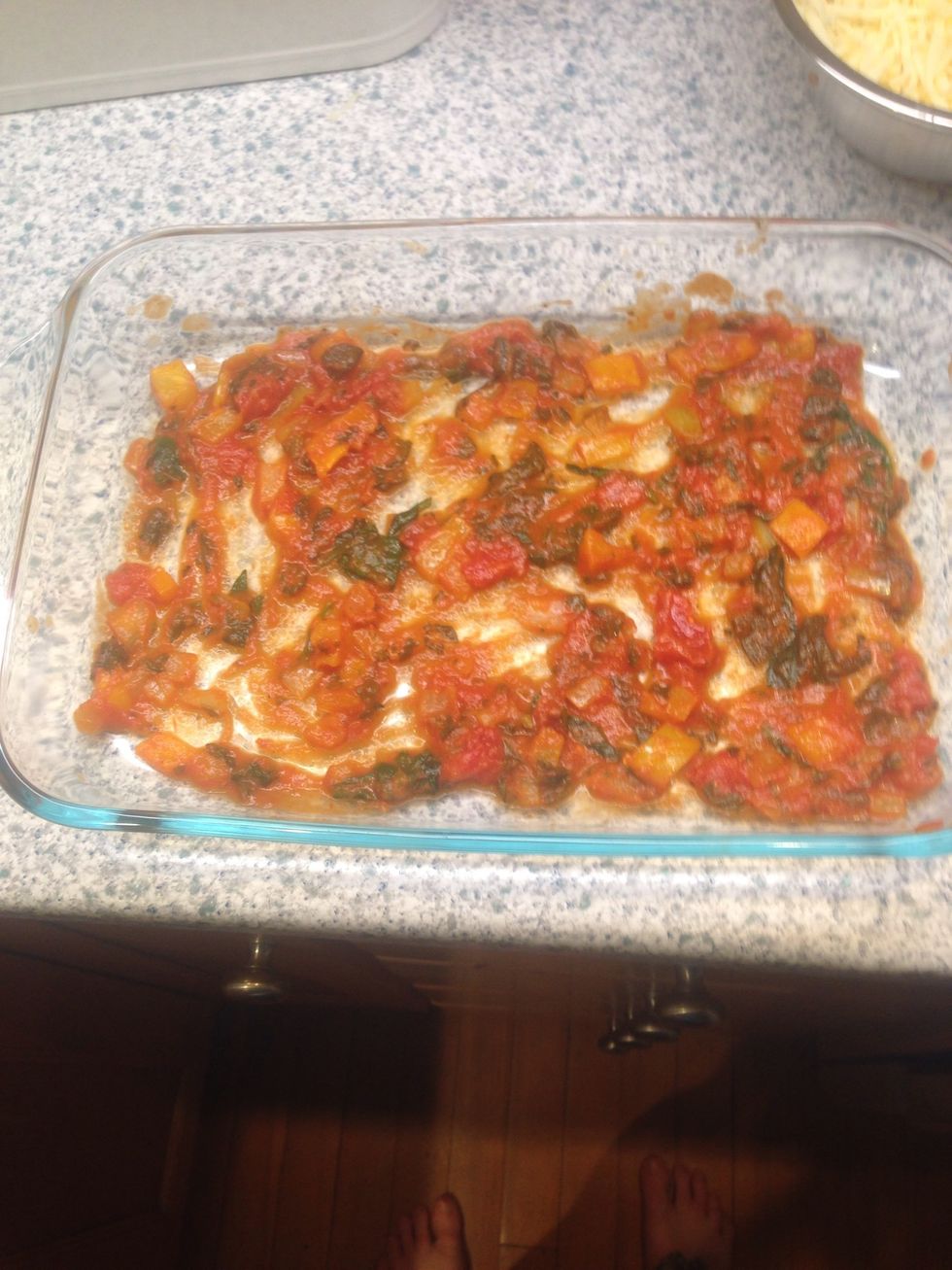Add some of sauce and vegetable mixture to bottom of casserole dish.