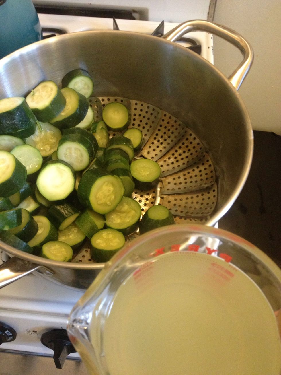 Add some of the warm, nutrient rich broth made by the water used to steam the zucchini to the blender. This is why you used filtered, not tap, water for steaming.