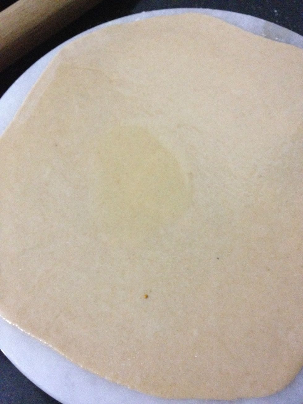 Add some oil on rolled dough and spread with hand or spoon