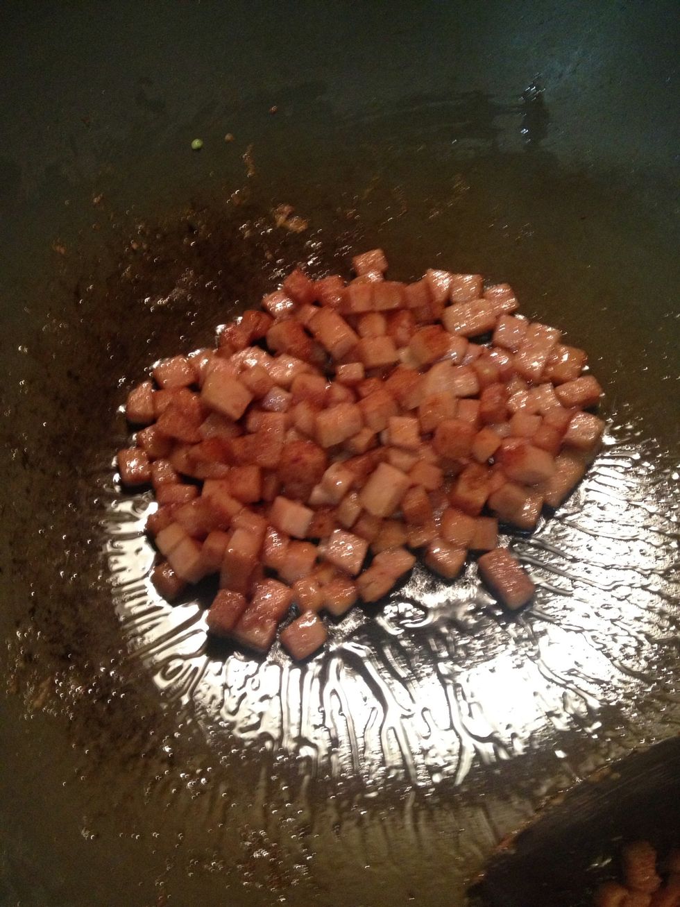 Add some oil to the wok and fried the luncheon meat in medium heat for about 3 minutes.