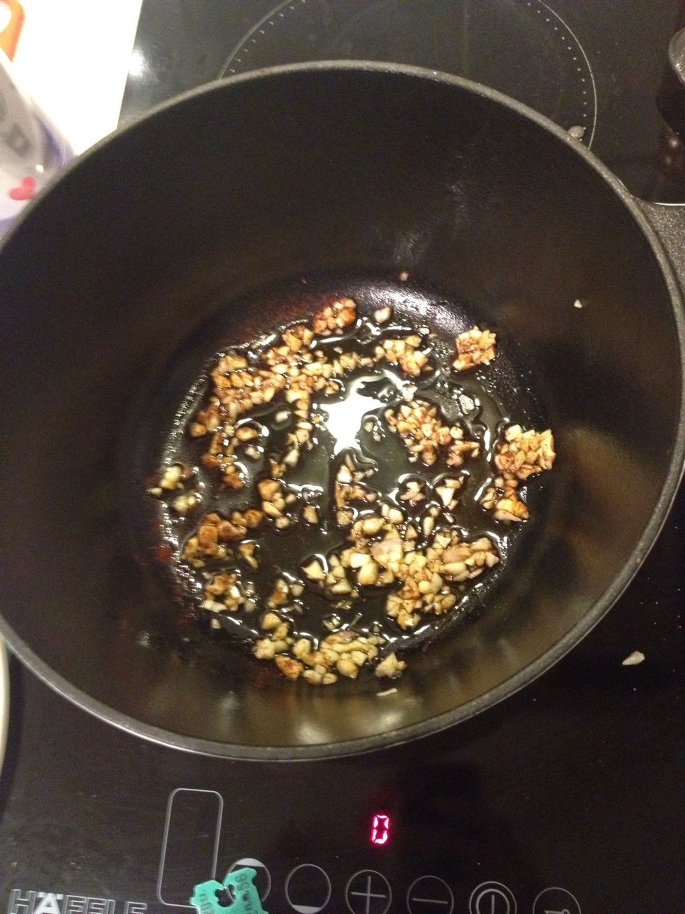 Add some olive oil and the rest of the garlic in sprinkle with some paprika. Turn on the heat. The casserole is a thick cast iron pan. It might take time to heat up.