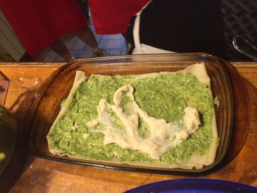add some pesto sauce and fresh white sauce to the sheet of pasta