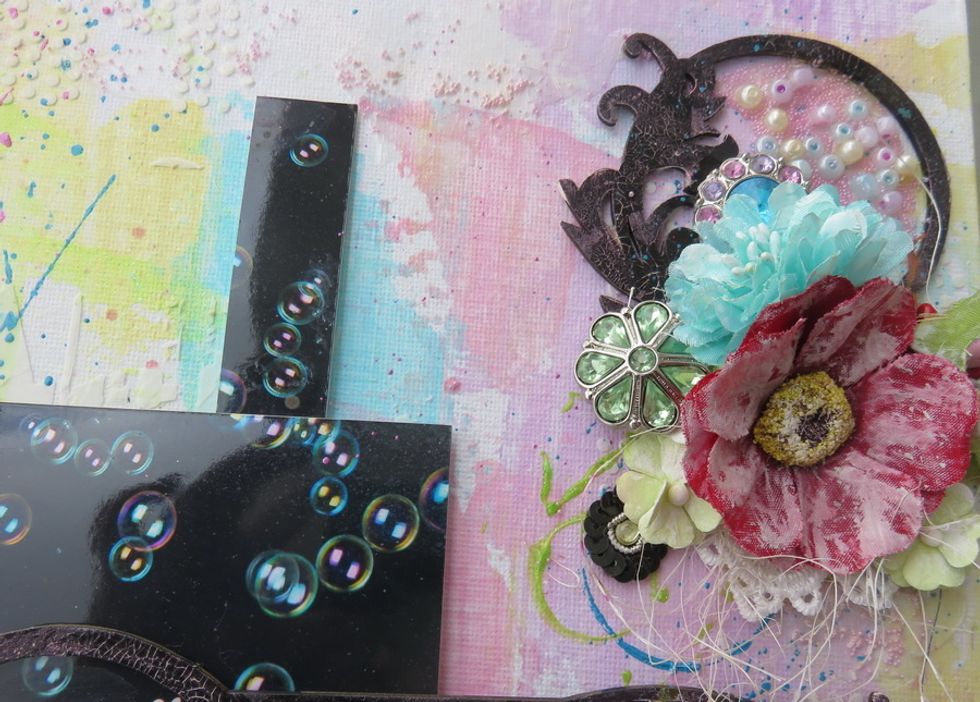 Add some pink micro beads over the canvas as seen.