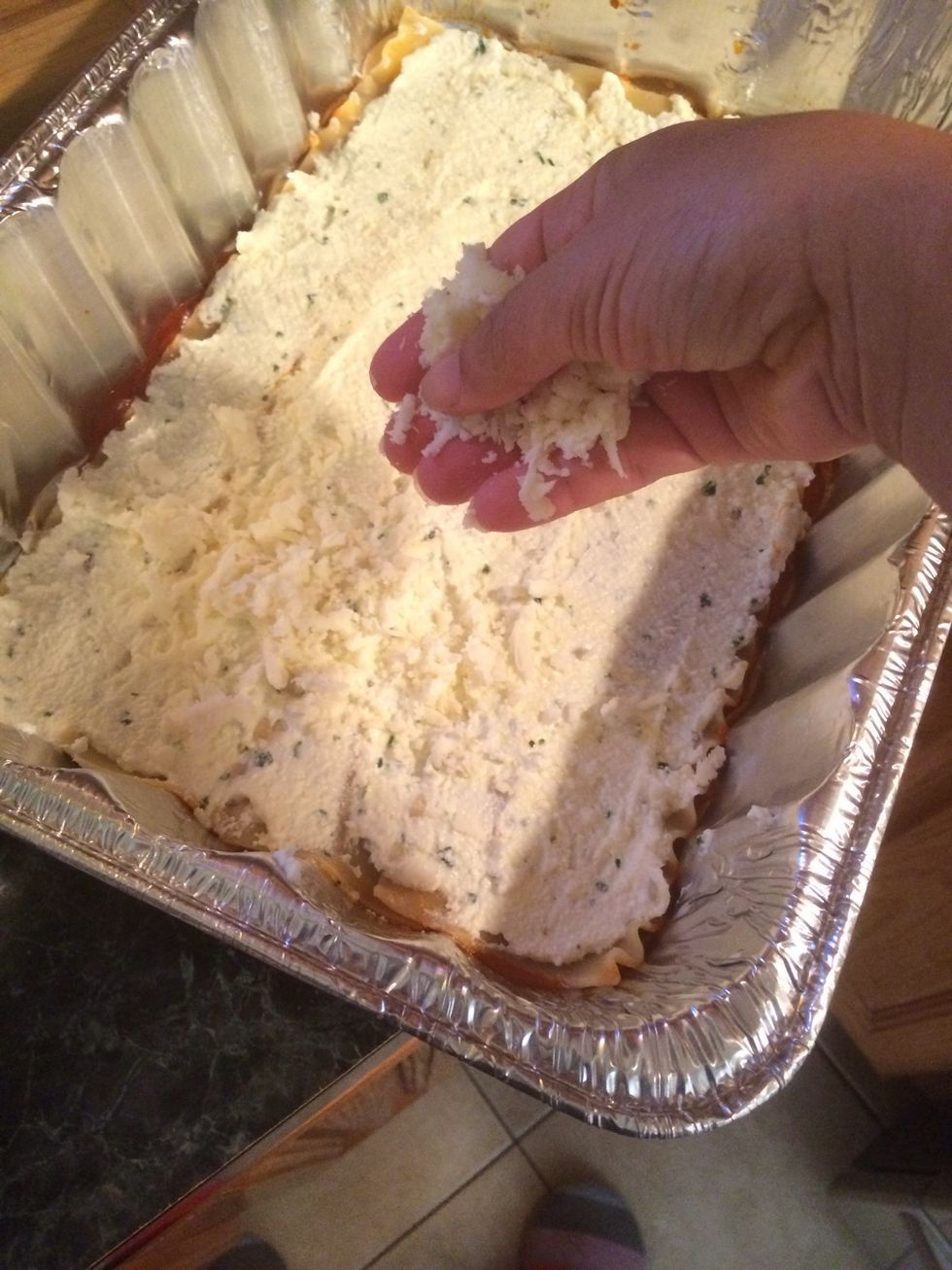 Add some shredded mozzarella cheese on top of the ricotta.