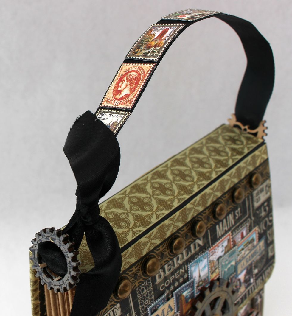 Add some stamps from the Well Traveled page to the handle with double sided tape and a little glue.