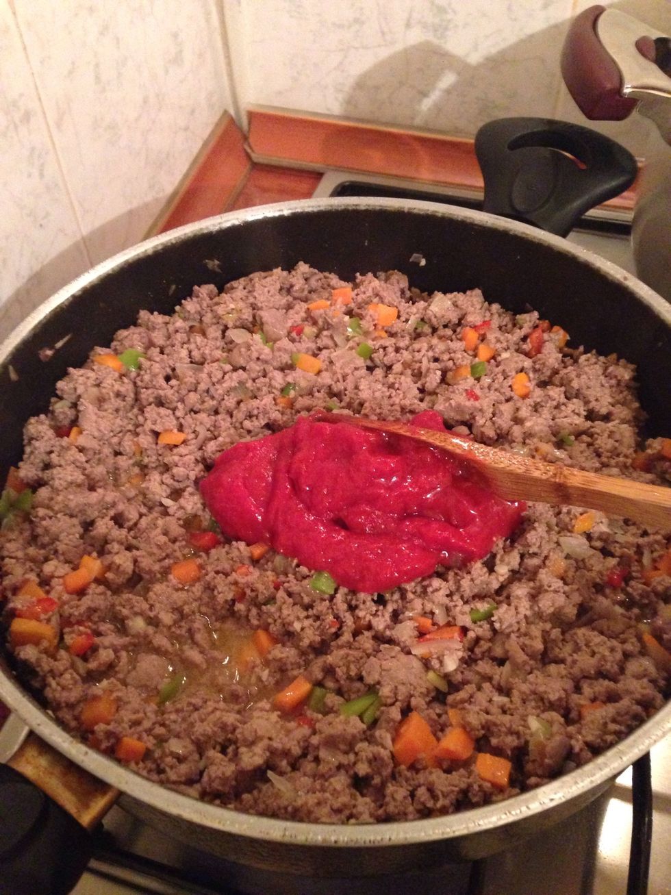 Add some tomato paste and the seasonings, and stir until everything is mixed together.