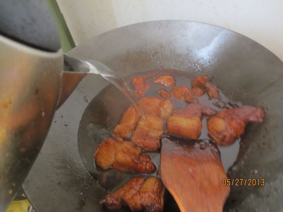 Add some water, just enough that it doesn't cover the pork belly completely