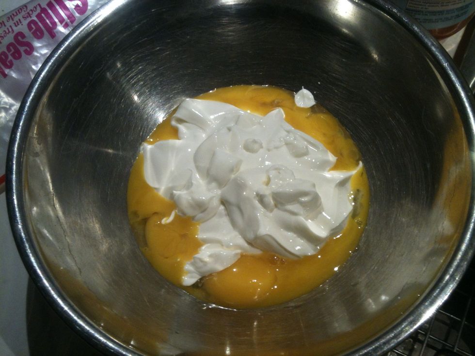 Add sour cream to the egg yolks.