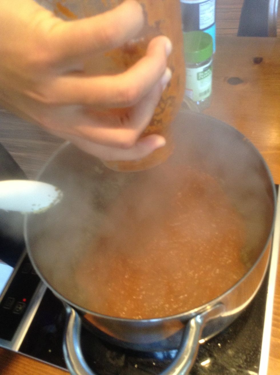 Add spaghetti sauce to cooking pot.