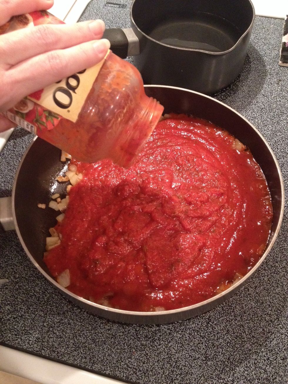 Add spaghetti sauce to onions and oil. Stir well.