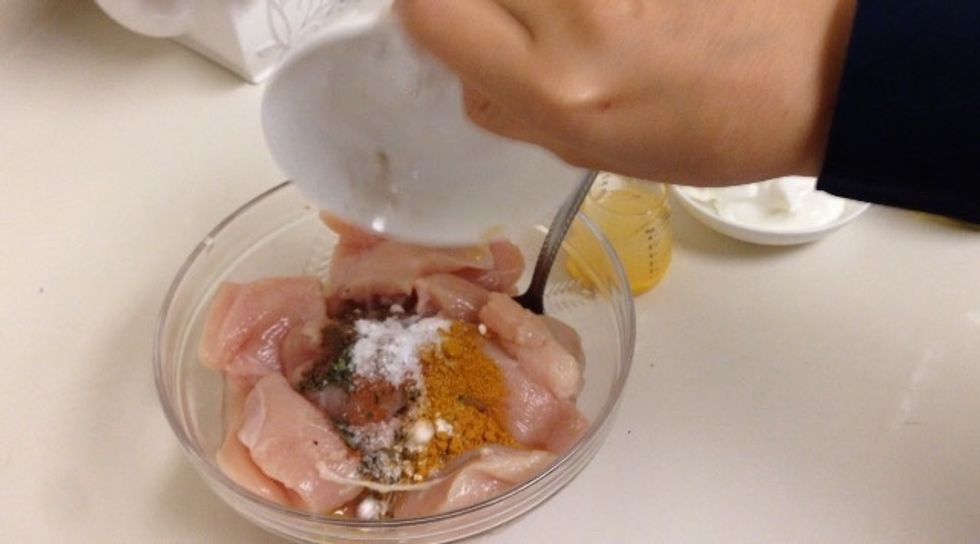 Add spices to chicken