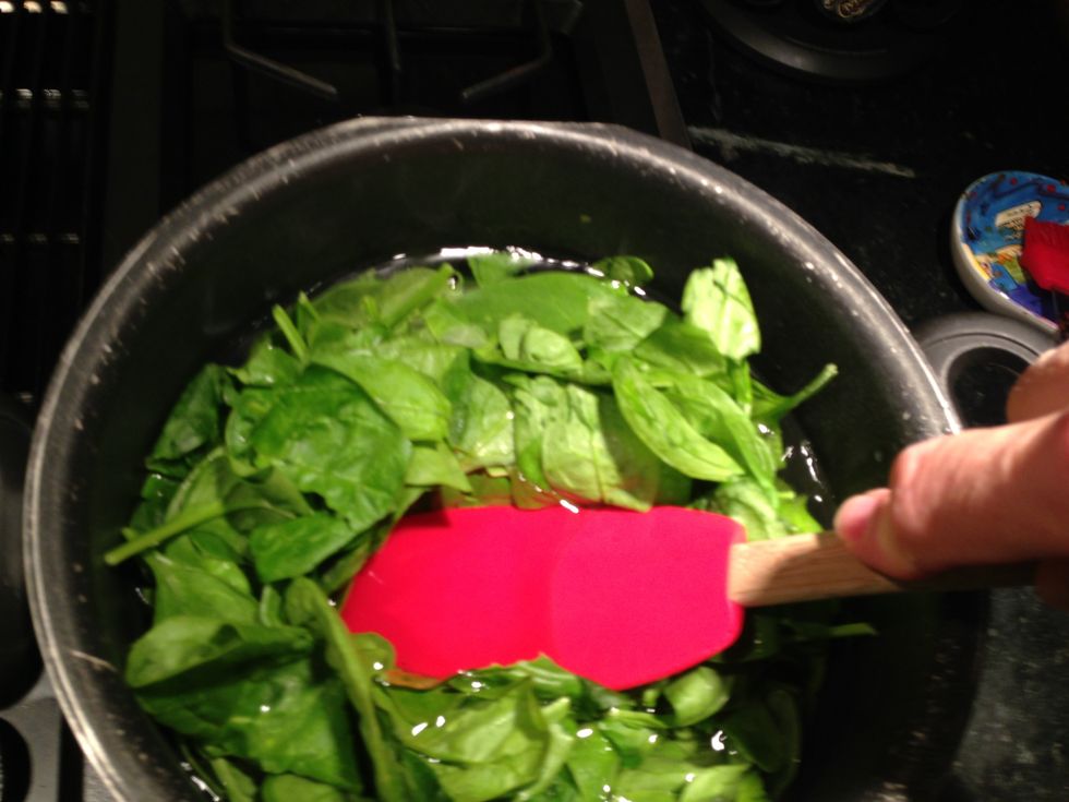 Add spinach, and shove it into the water. Get it submerged.