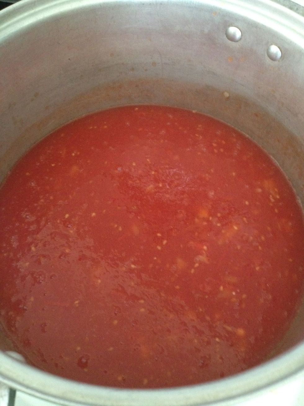 Add stewed tomatoes. If you use fresh tomatoes, you'll need to boil those down and using an immersion blender or regular blender to blend tomatoes until smooth.