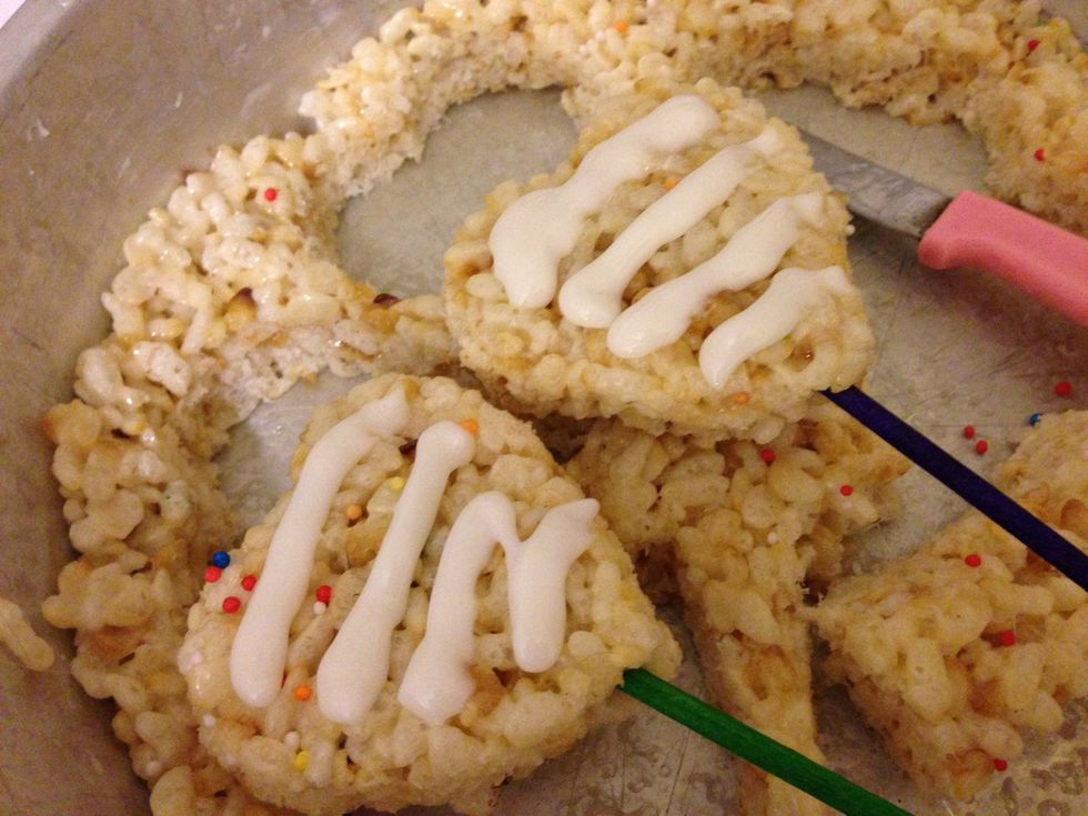 Add stick to each cookie, then add royal icing