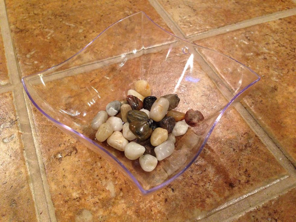 Add stones, glass pieces, moss, shells, or sticks.  Keep the container as light as possible for the suction cup to hold well.