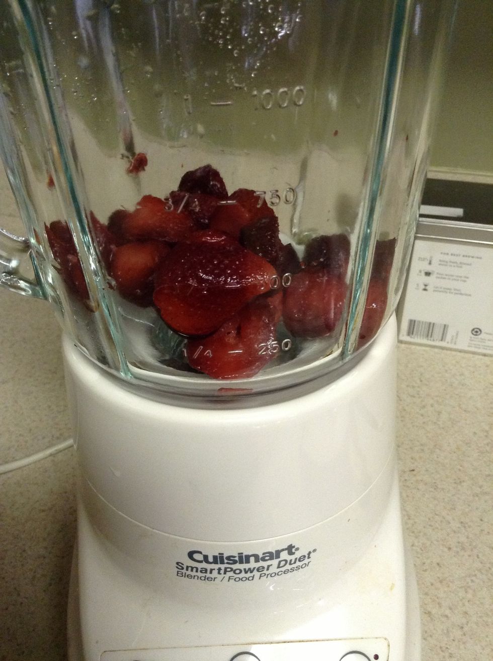 Add strawberries to the bottom of the blender.