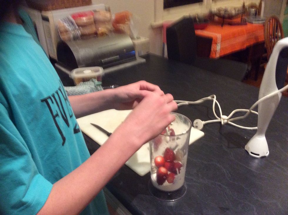 Add strawberries to the cup