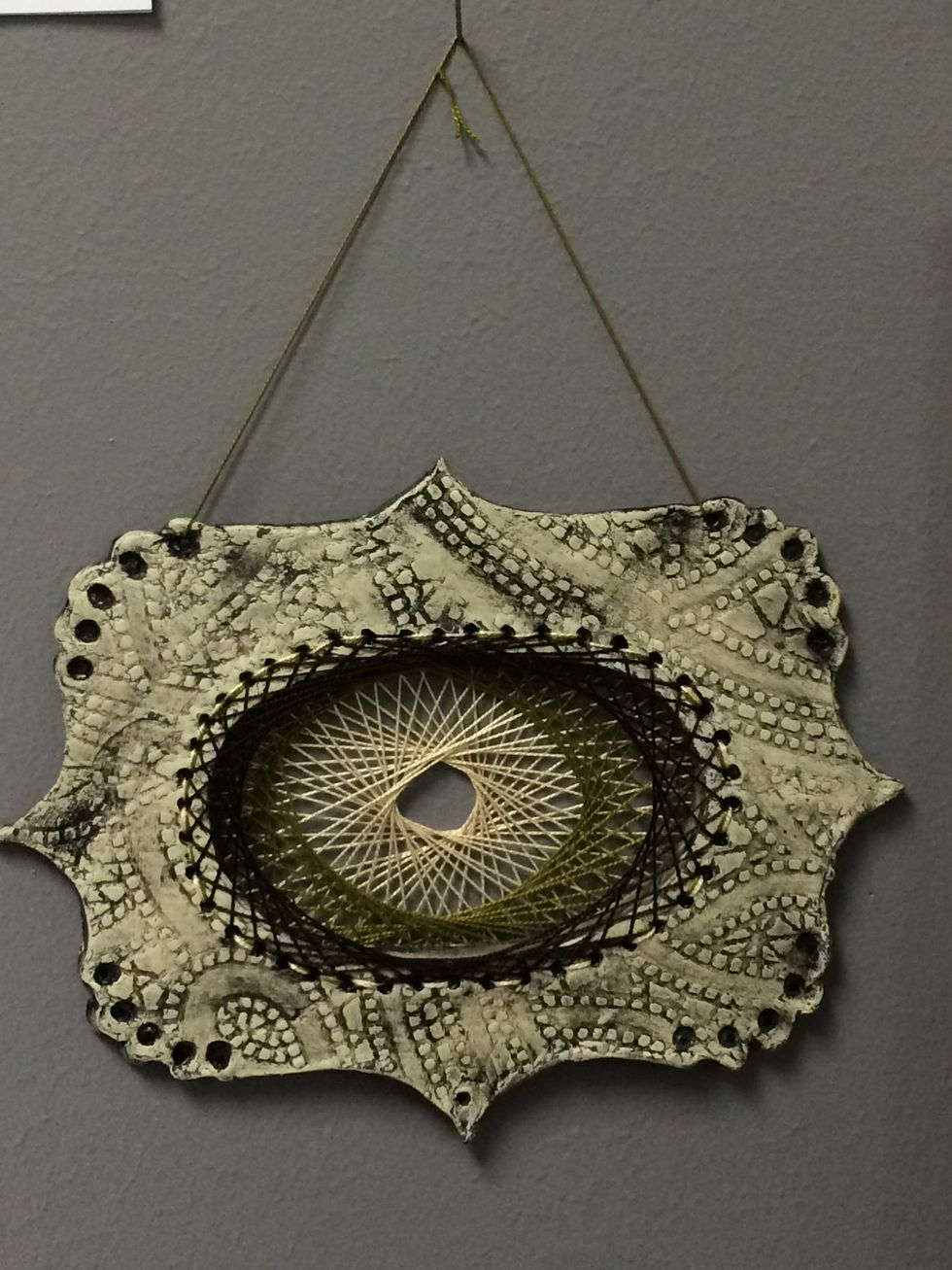 Add string to hang the loom sculpture for display.