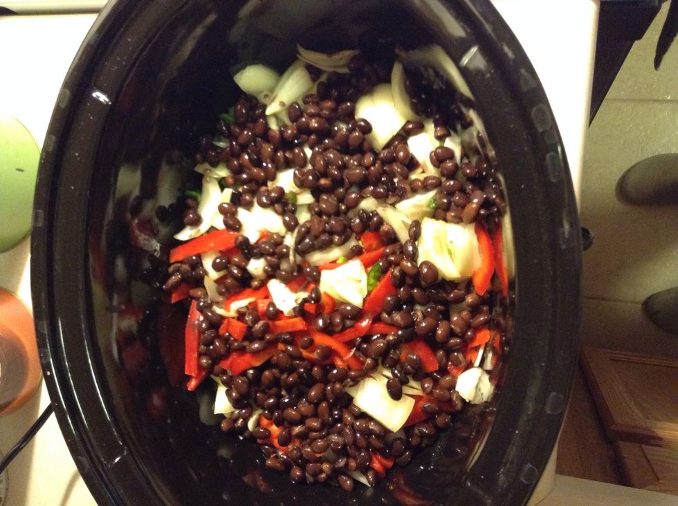 Add stripped red bell peppers, minced onion, garlic, jalape\u00f1o, & black beans to the top. Cook on low for 7-8 hours until chicken is tender. Or if you want to cook it on high heater for 4 hours.