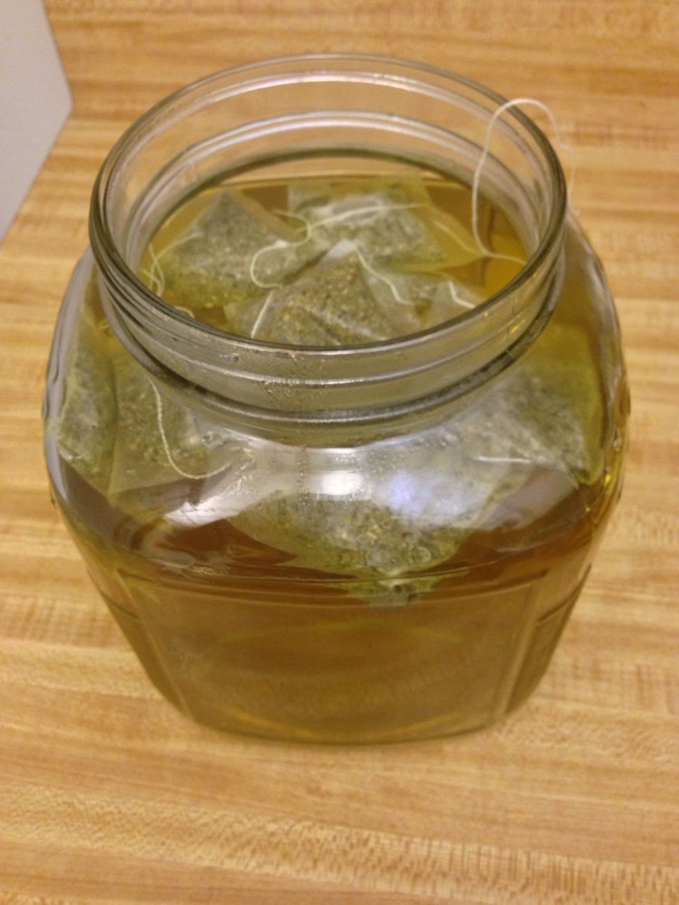 Add sugar and tea bags with paper removed from string. Steep for ten minutes, then remove tea bags.