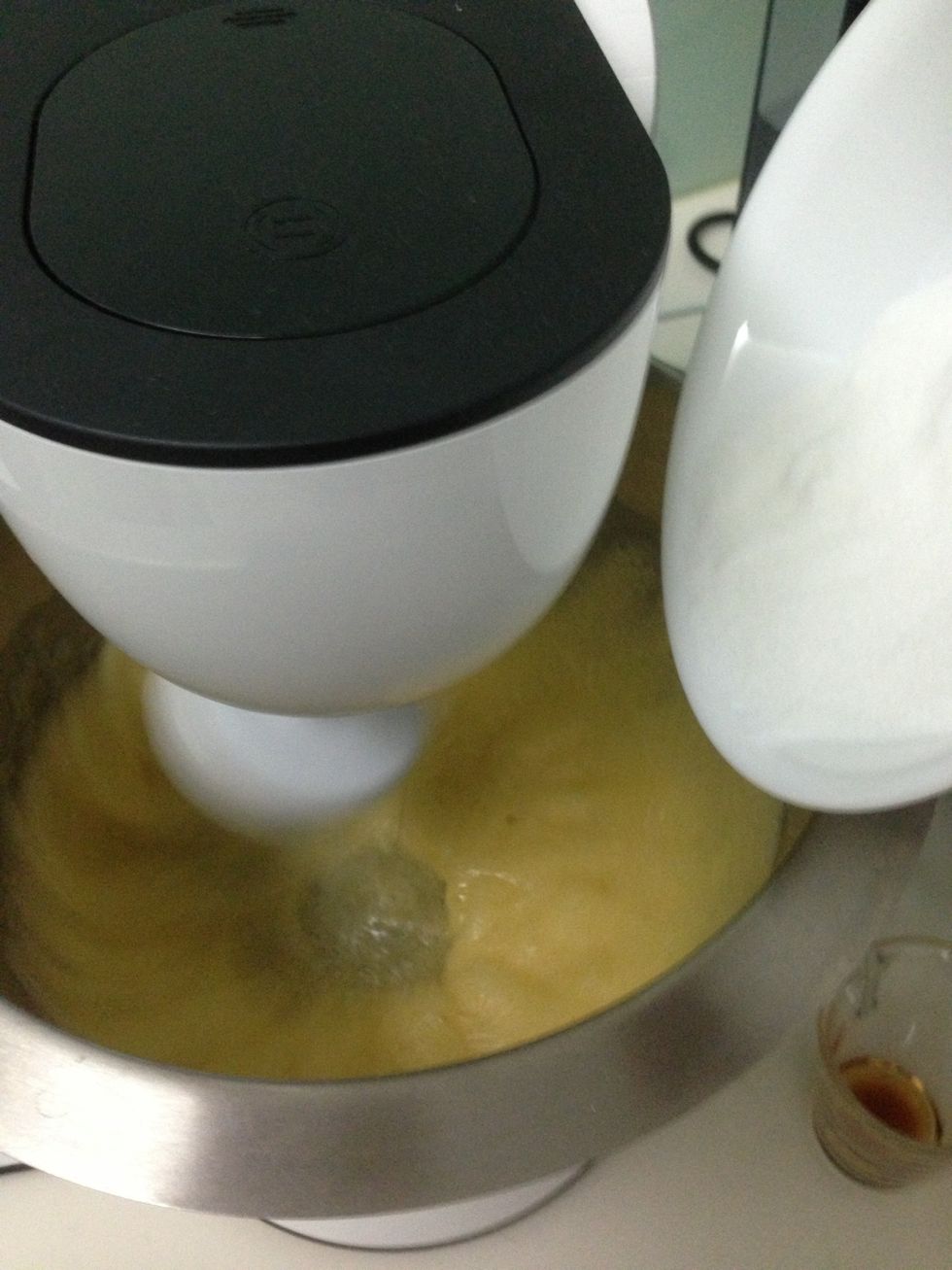 Add sugar slowly, then rum and vanilla extract