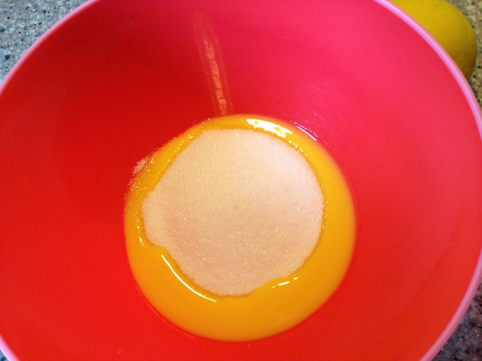 Add sugar to egg yolks