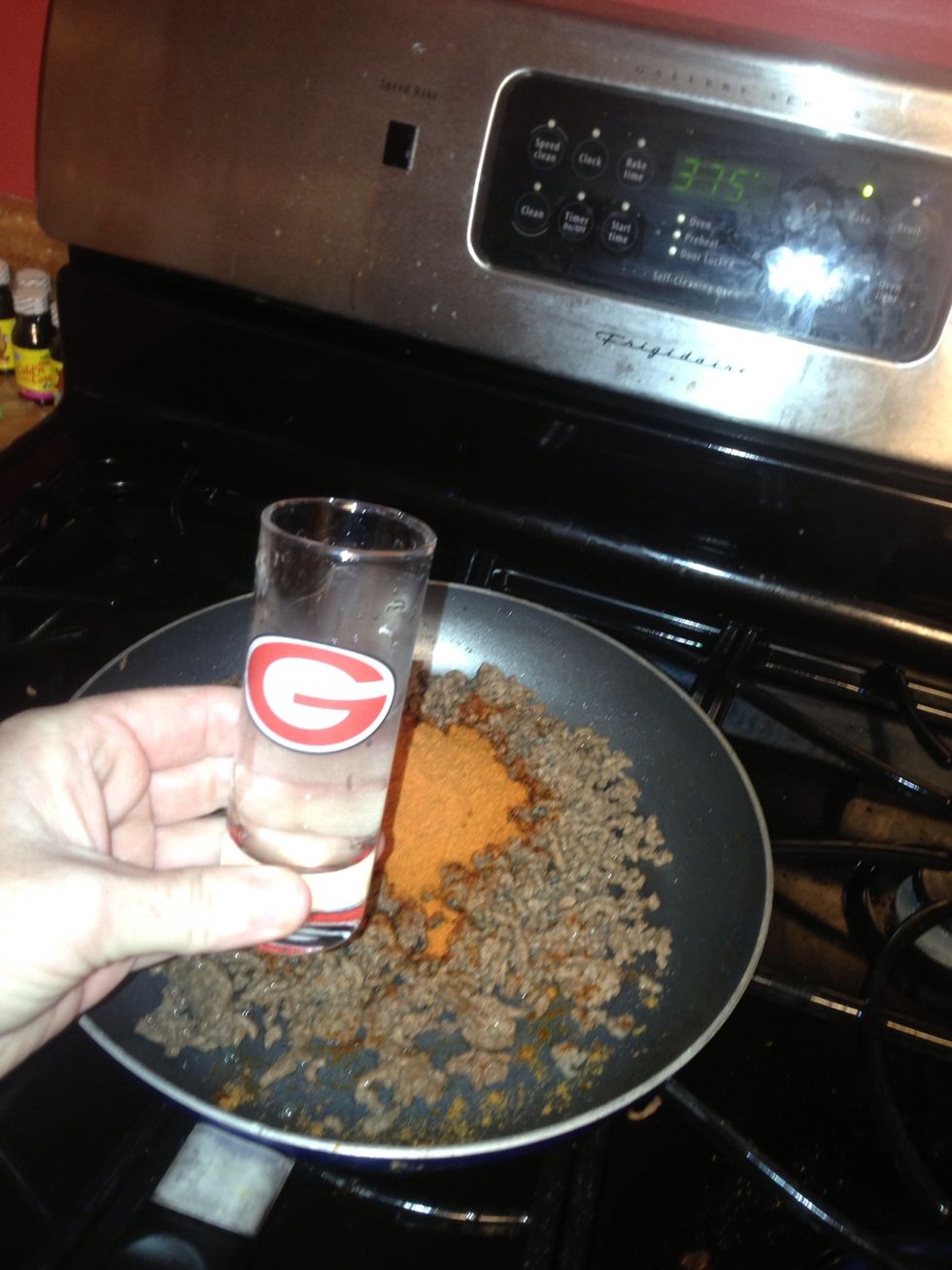 Add taco seasoning and a small shot glass of water (or 2 tablespoons if you want to measure) I use my handy UGA glass ;) stir and simmer for 2 min and then remove from heat.