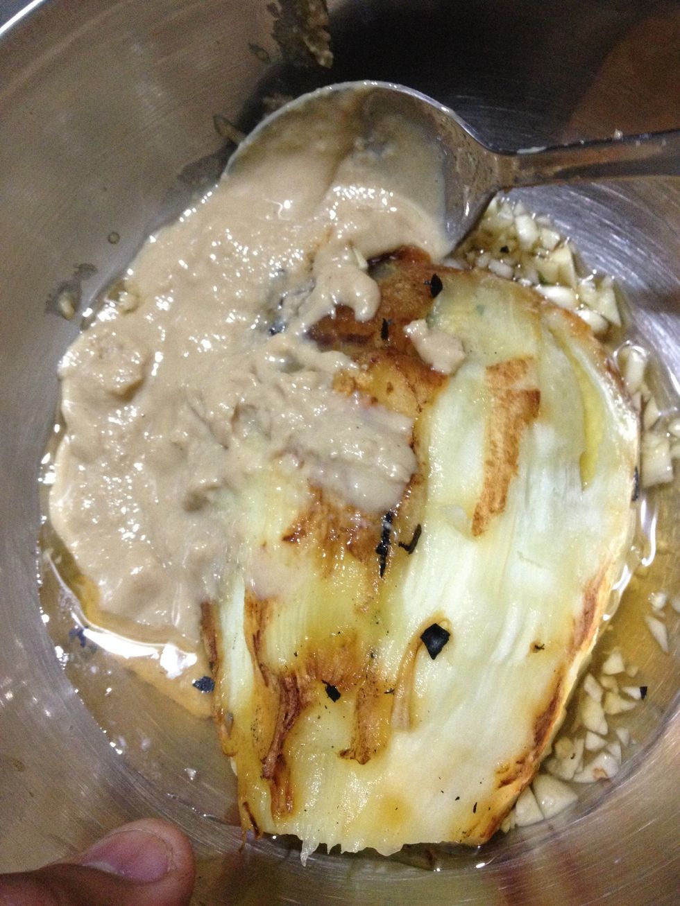 Add tahini paste to it . (Tahini paste is roasted sesame seeds ground into a fine paste using olive oil. )