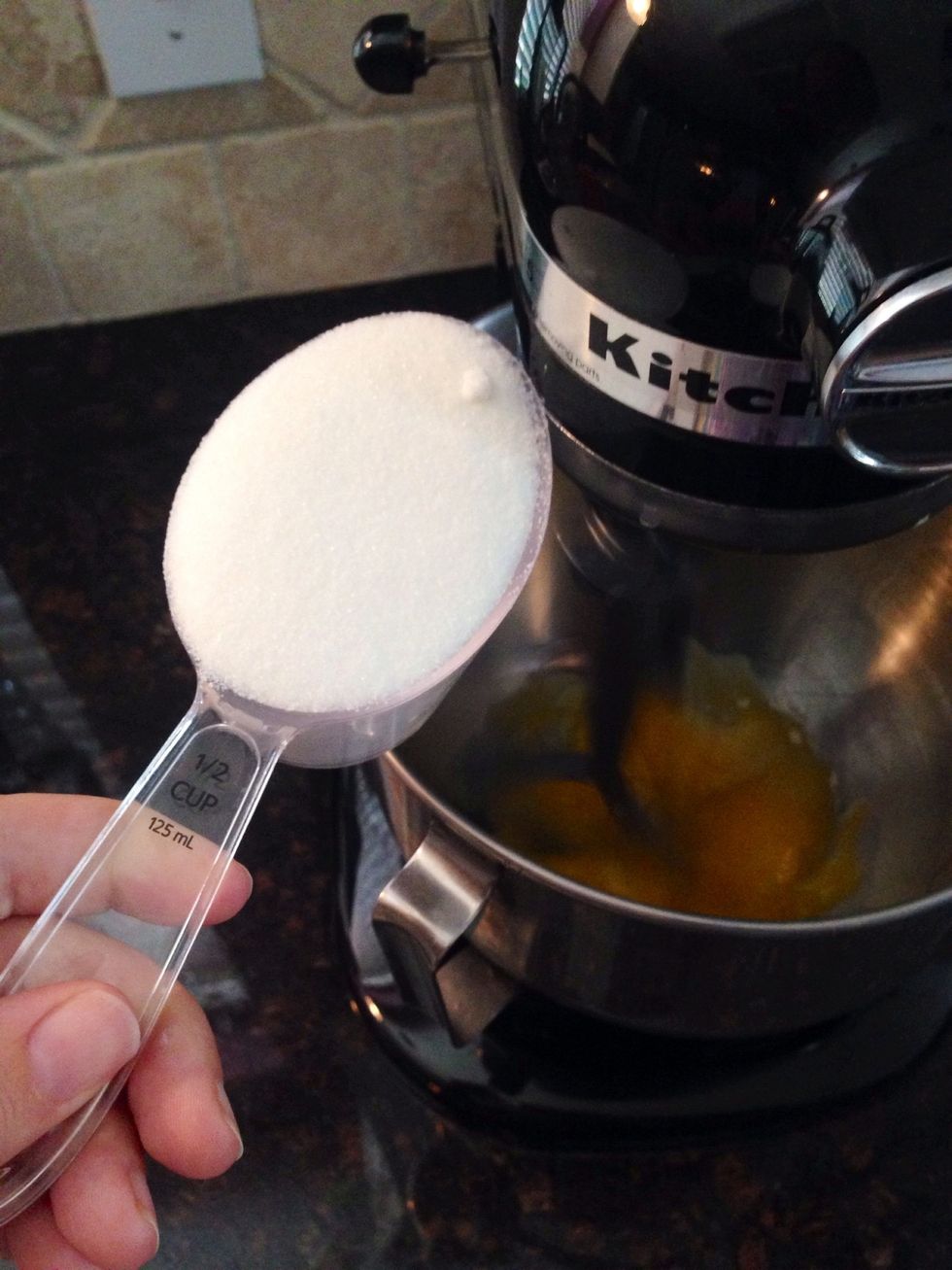Add the 1/2 cup of white sugar to the yolks as they continue to beat.