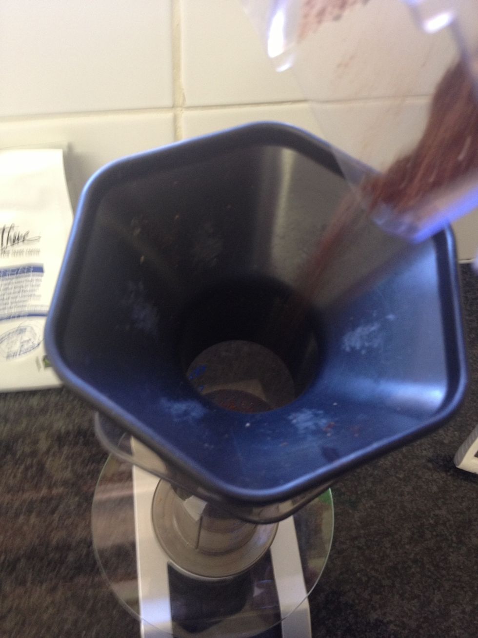 Add the 16g of ground coffee and zero your scale so that you can weigh the water for the two stage pour.