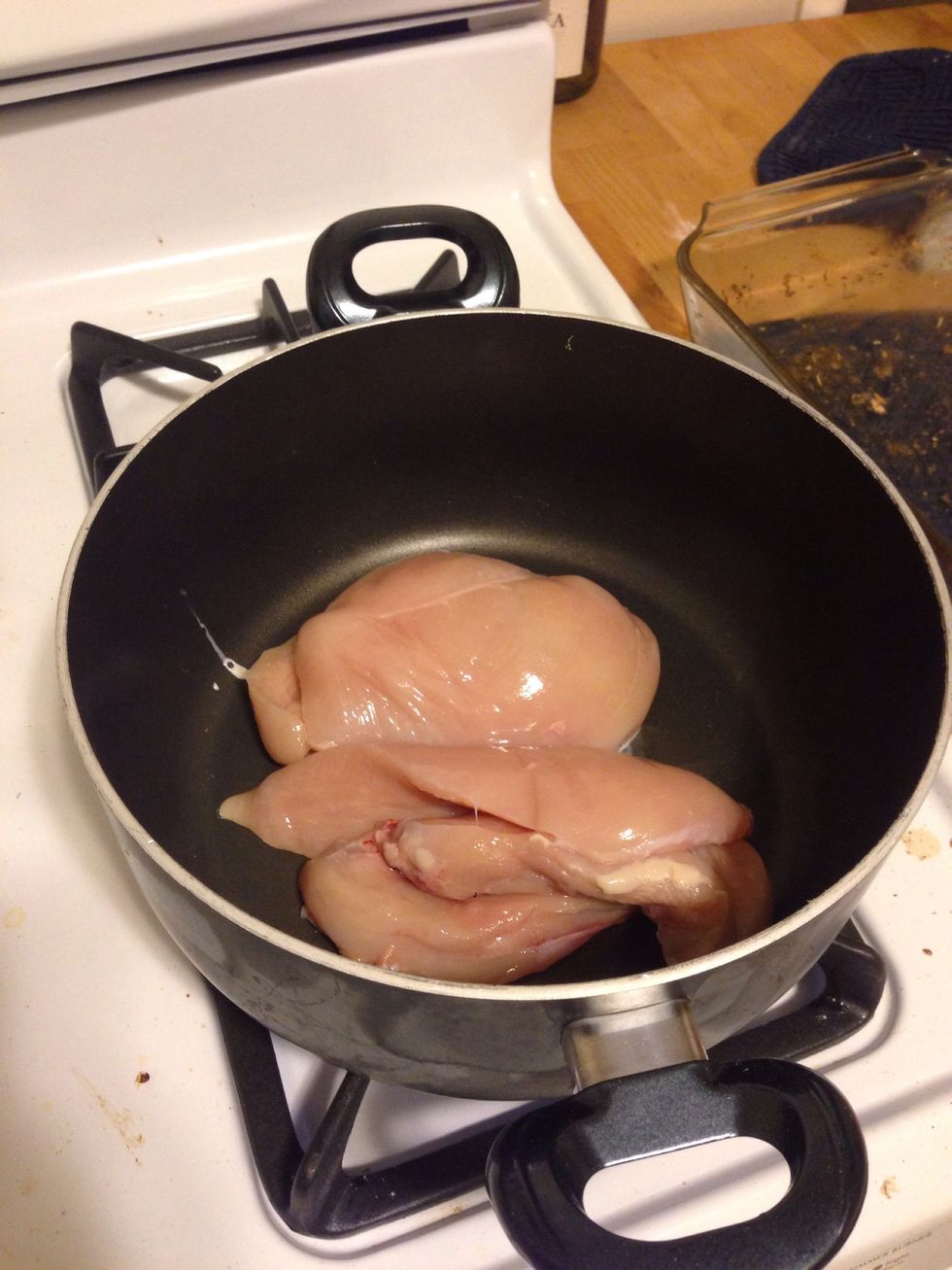 Add the 2 chicken breasts. I sliced them in the middle so they would cook faster.