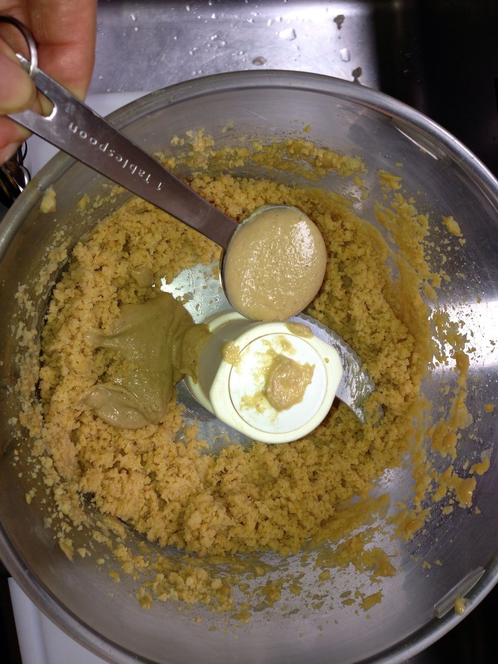 Add  the 2 TBsp tahine+2TBsp water + 2 TBsp lemon juice + 1 tsp salt turn  ..scrap the sides turn untill desired consistency.  You can always add water for a more loose  hummus . Adjust lemon salt .