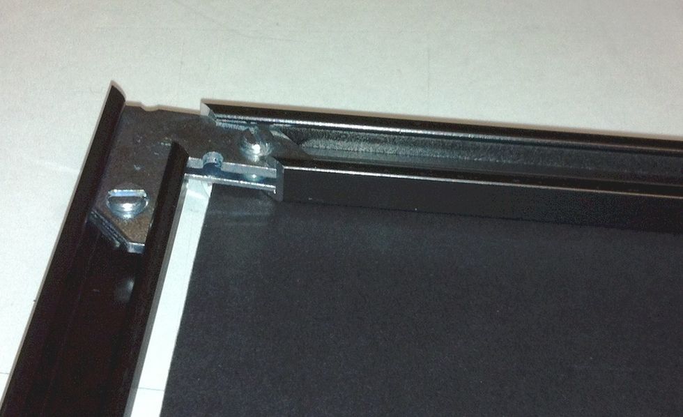 Add the 4th leg and tighten the screws. Carefully turn the piece over and look for fuzzies or smudges then return it to the face down position.