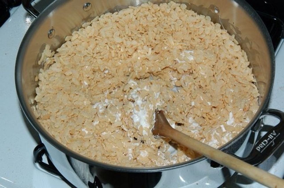 Add the 6 cups of Rice Krispies cereal . Stir until mixed well.