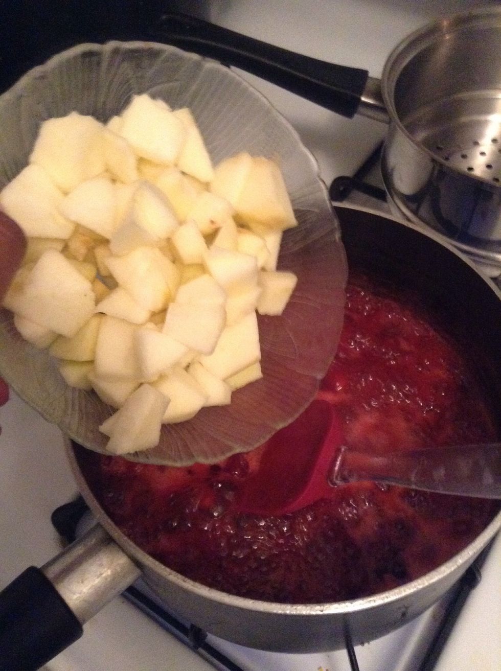Add the apples to the mixture ...also add in the pineapple juice from the can here as well as about 6 rings of pineapple and some more spiced apple cider