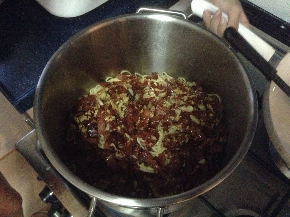 Add the bacon and mix with little olive oil. Mix the egg mixture then mix instantly. Add Apc then mix. Add Parmesan cheese.