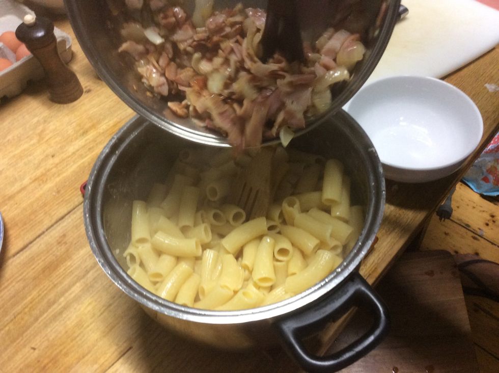 Add the bacon, onion and garlic into pasta. Note: pasta still needs to be hot during stirring process