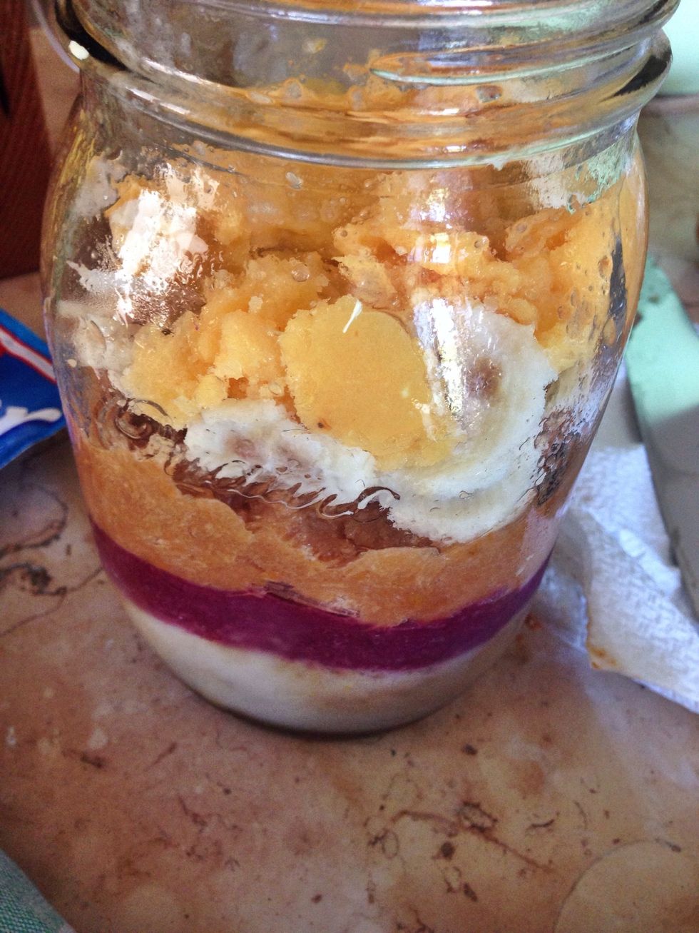 Add the banana slices and the banana orange mix, keep pressing down with a spoon