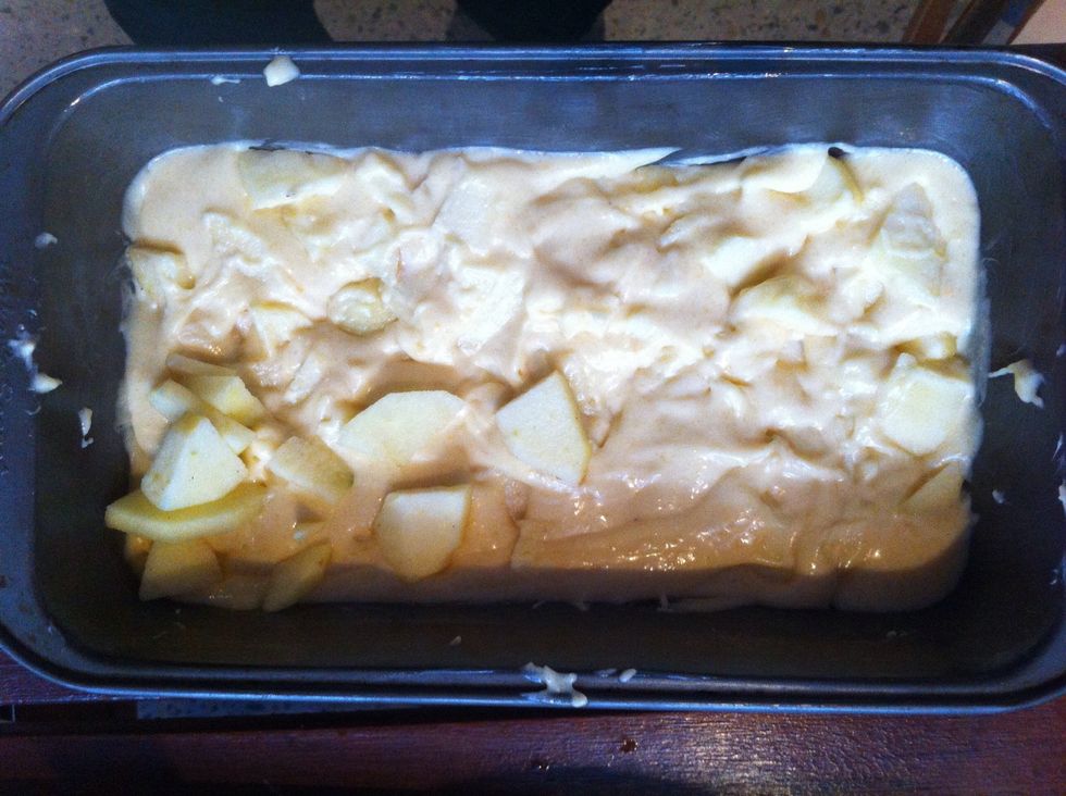 Add the batter and the apples into a cake pan. Don't forget to butter the pan first