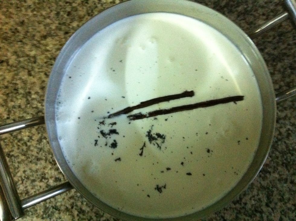 Add the beans and pods into a stainless steel pot along with the cream and milk. I cut each half of the vanilla pod in half cross-wise so it would fit in the pot. Heat gently over low heat.