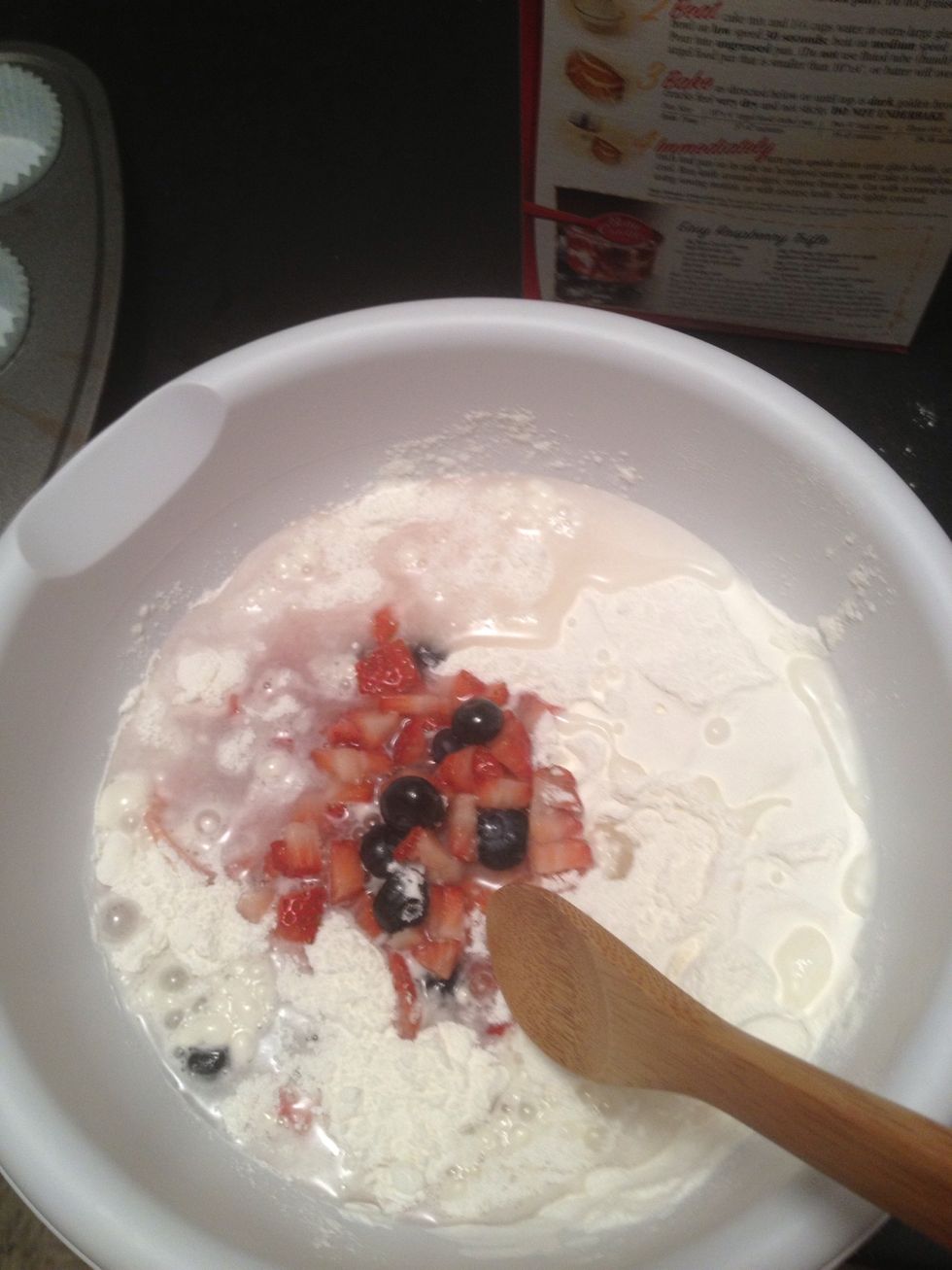 Add the berry syrupy mixture to the cake mix and stir until you get a batter like consistency. Then add to the cupcake tin. Into the oven we go!
