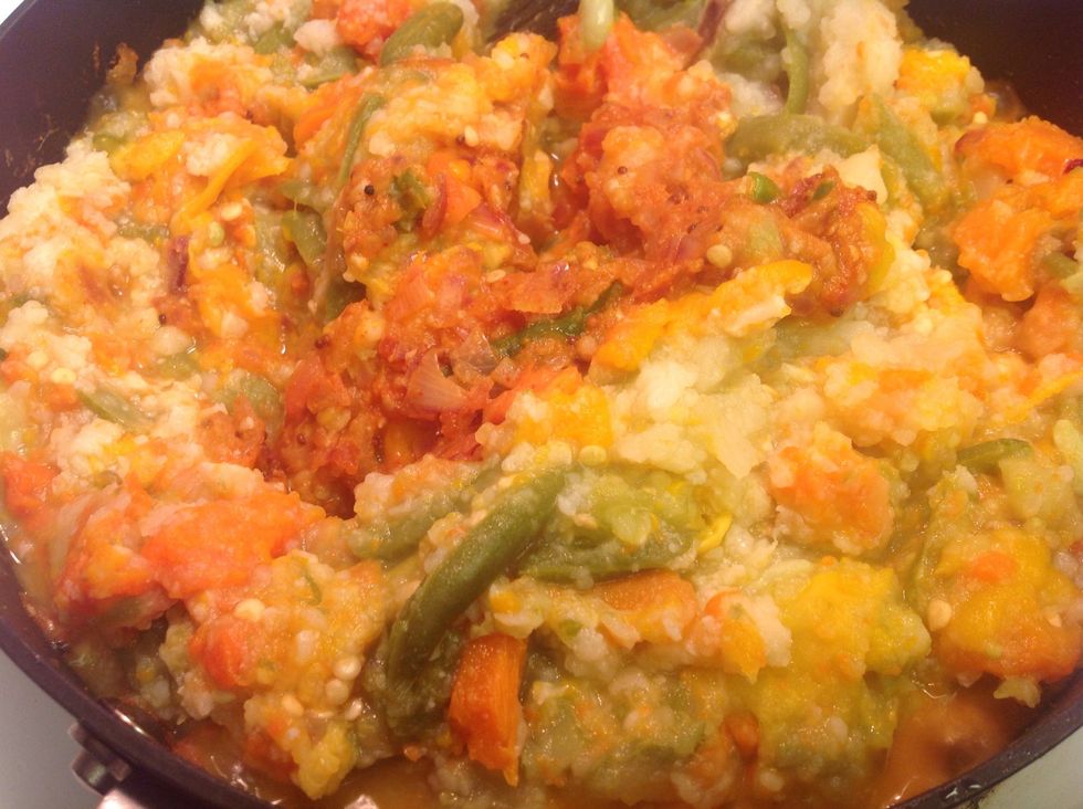 Add the boiled veggies to the onion and tomato mixture on the stove.