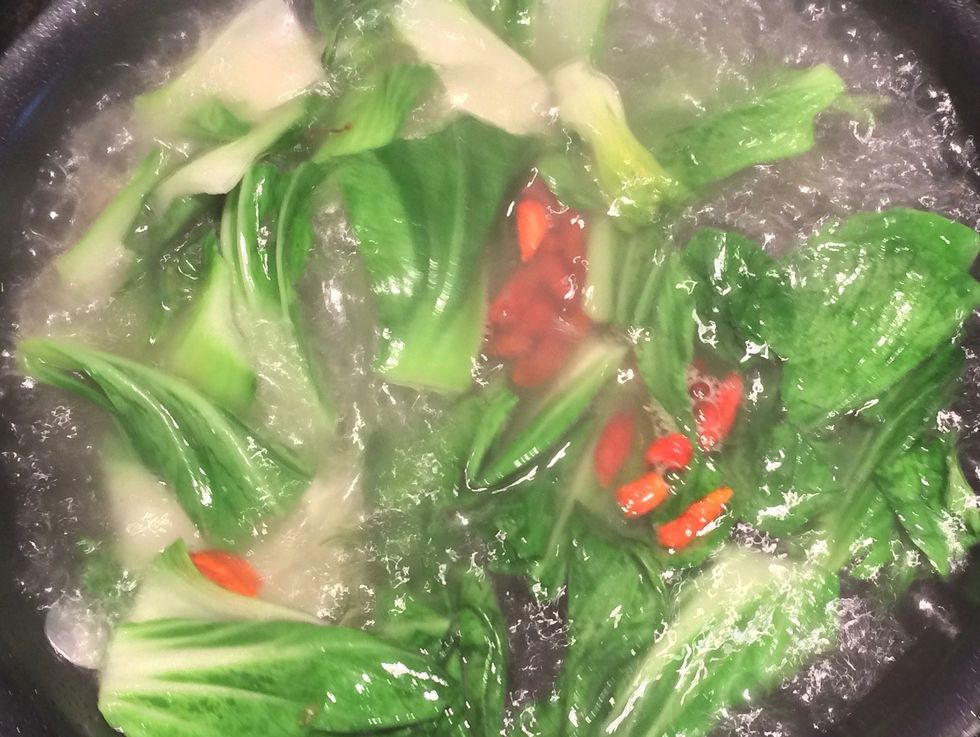 Add the bok choy to the frying pan. Stir fry for 1 minute. Add 1 cup of water (either boiled or room temperature) and goji berries. Allow water to boil. Cook for 1 minute.