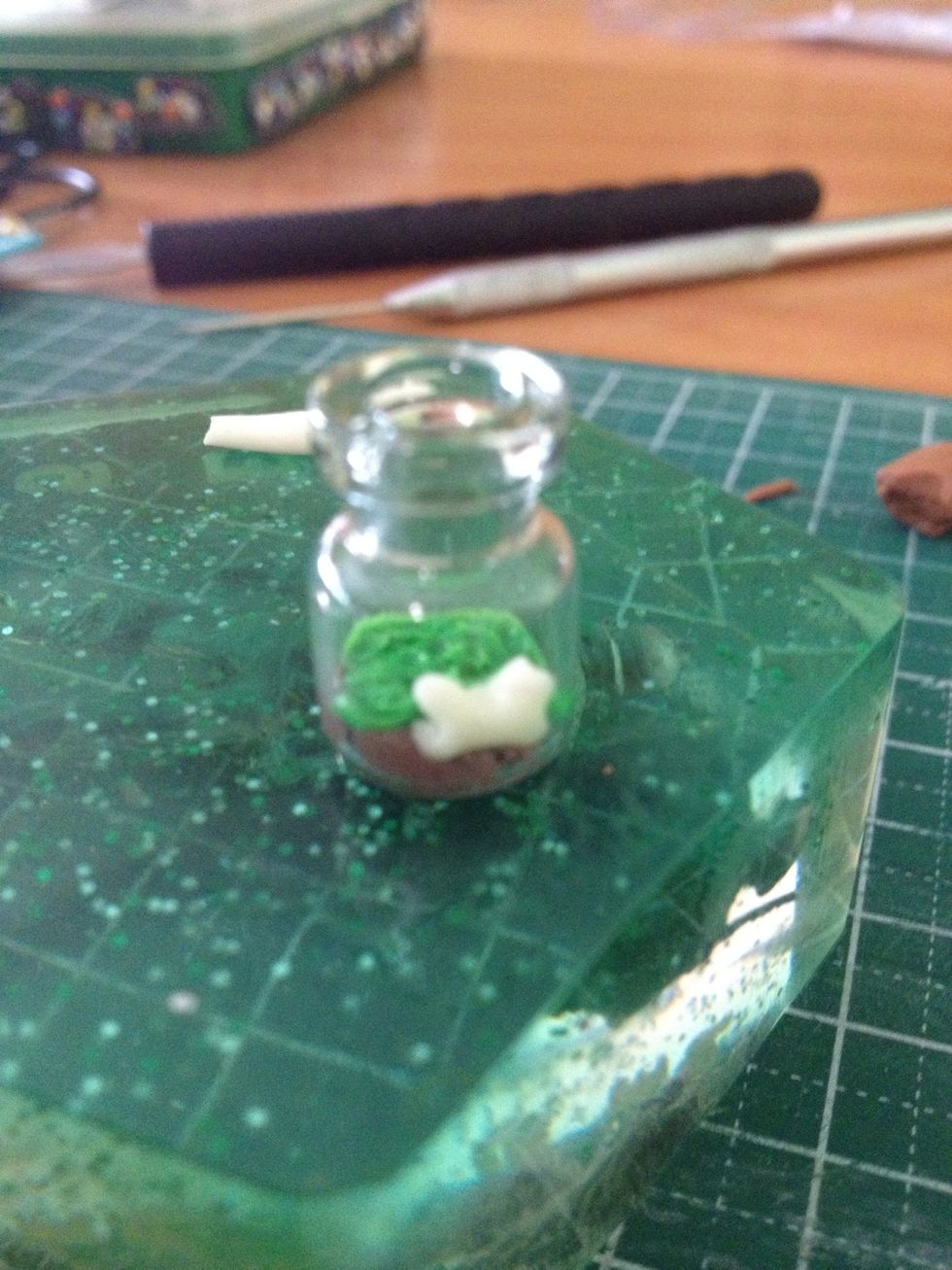 Add the bone, ensure it's pushed into the layers of soil and grass. Then the stalk. To place the mushroom cap on the stalk securely, add a bit of TLS into the underside of the cap.