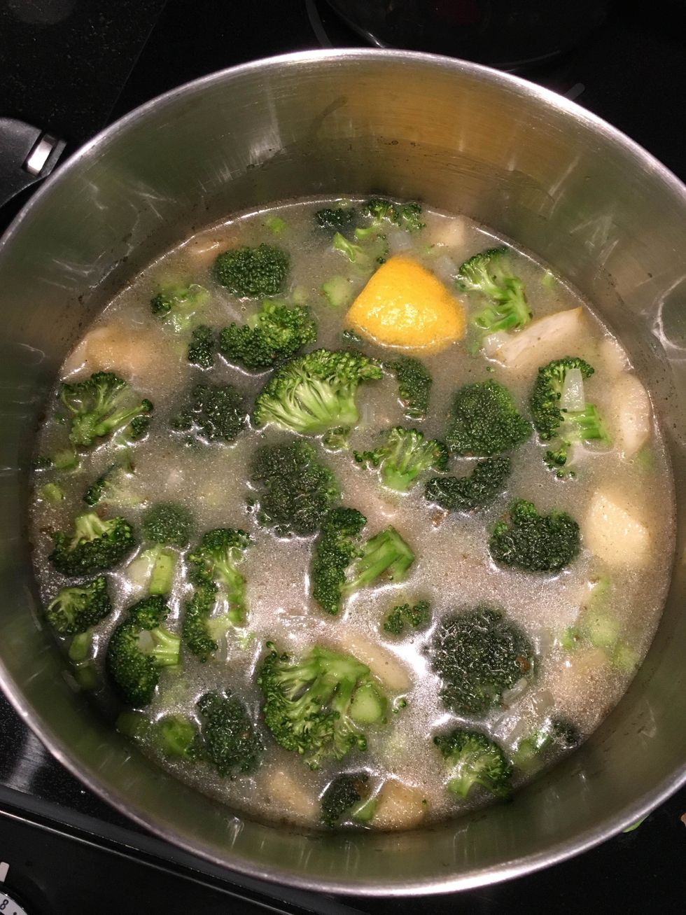 Add the broccoli florets and stems, as well as the chicken stock, apple juice, thyme, and lemon peels to the mixture. Cover, and cook on low for 20-25 minutes.