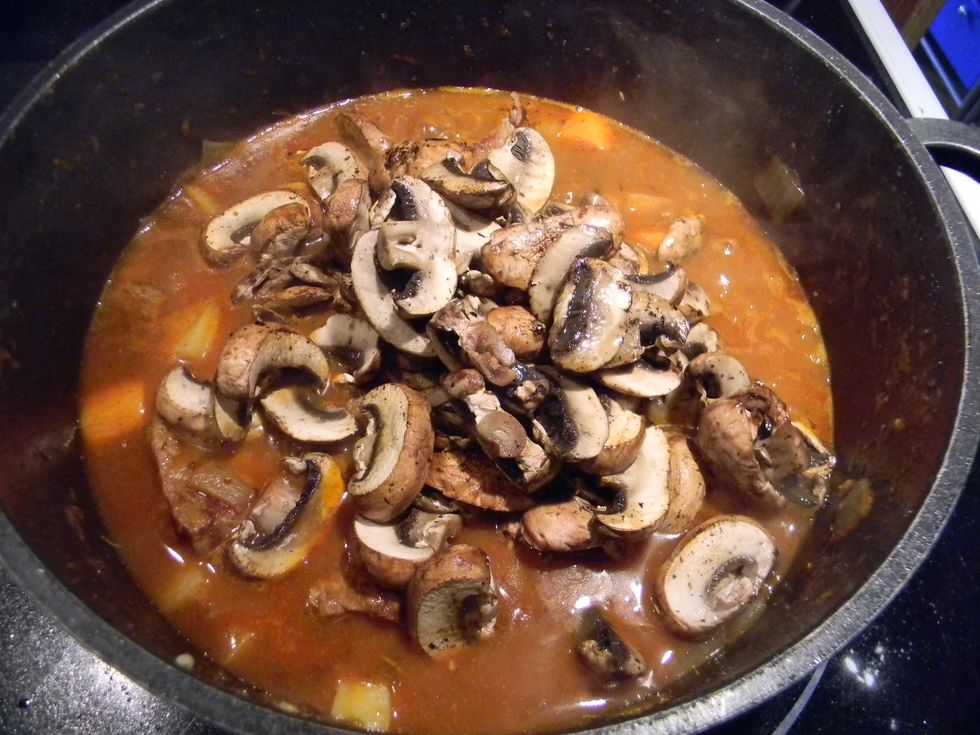 Add the browned mushrooms to the stew.