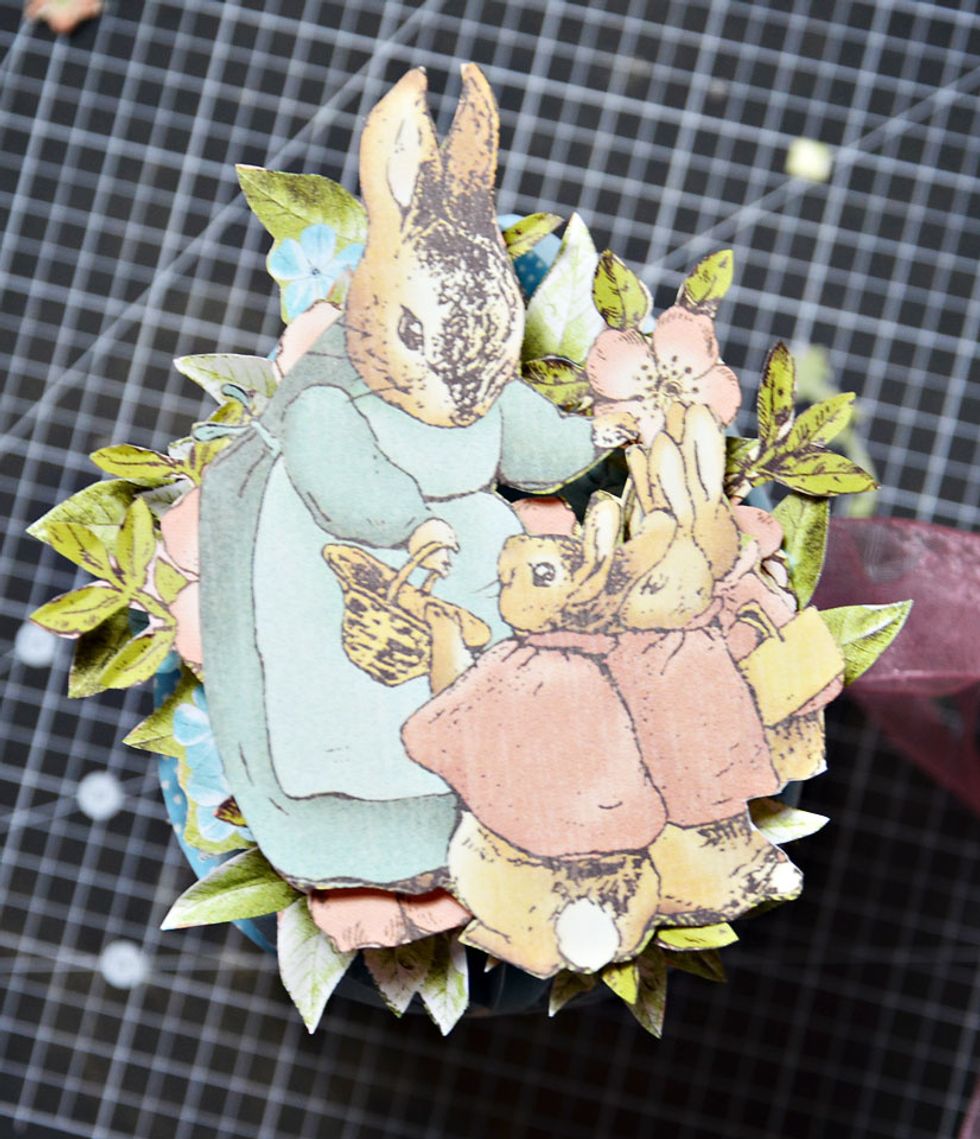 Add the bunnies from the Graphic 45 Once Upon A Springtime collection paper and the front of your egg is complete.